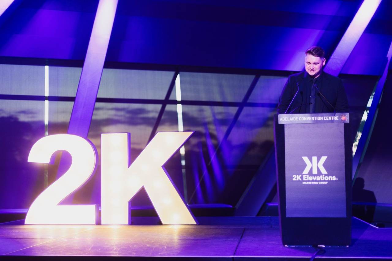Elijah speaking at the 2K Gala podium
