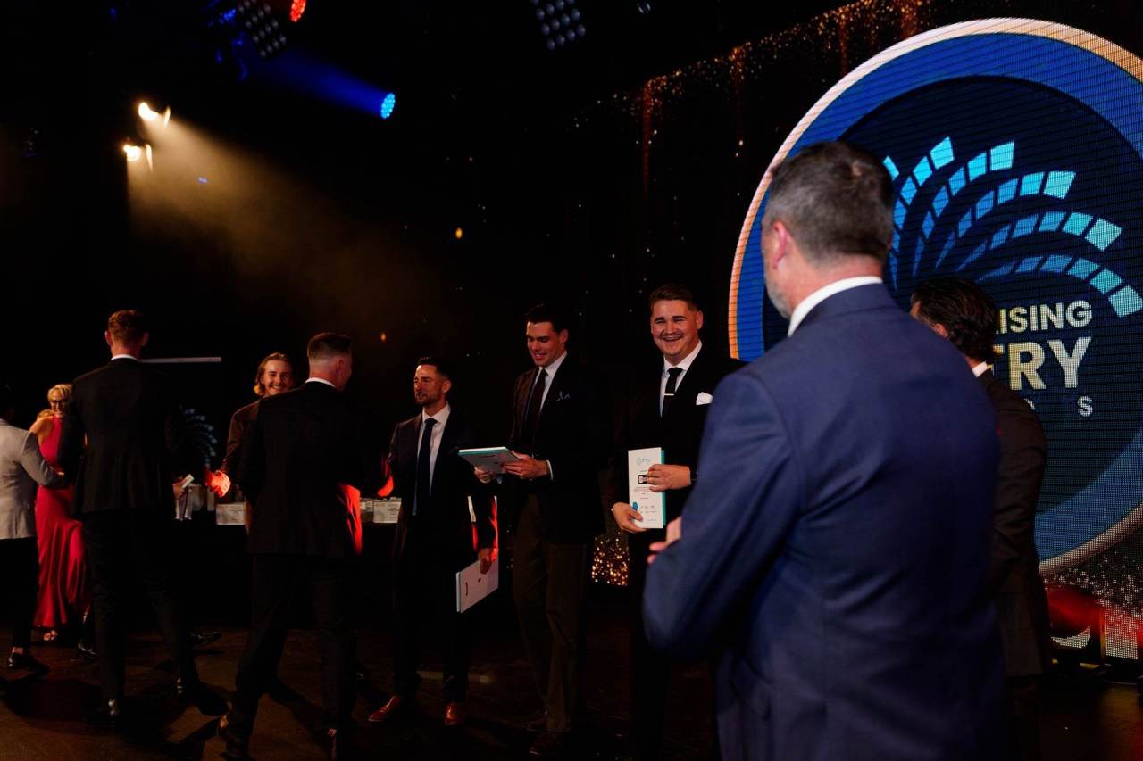 Leaders shaking hands on stage