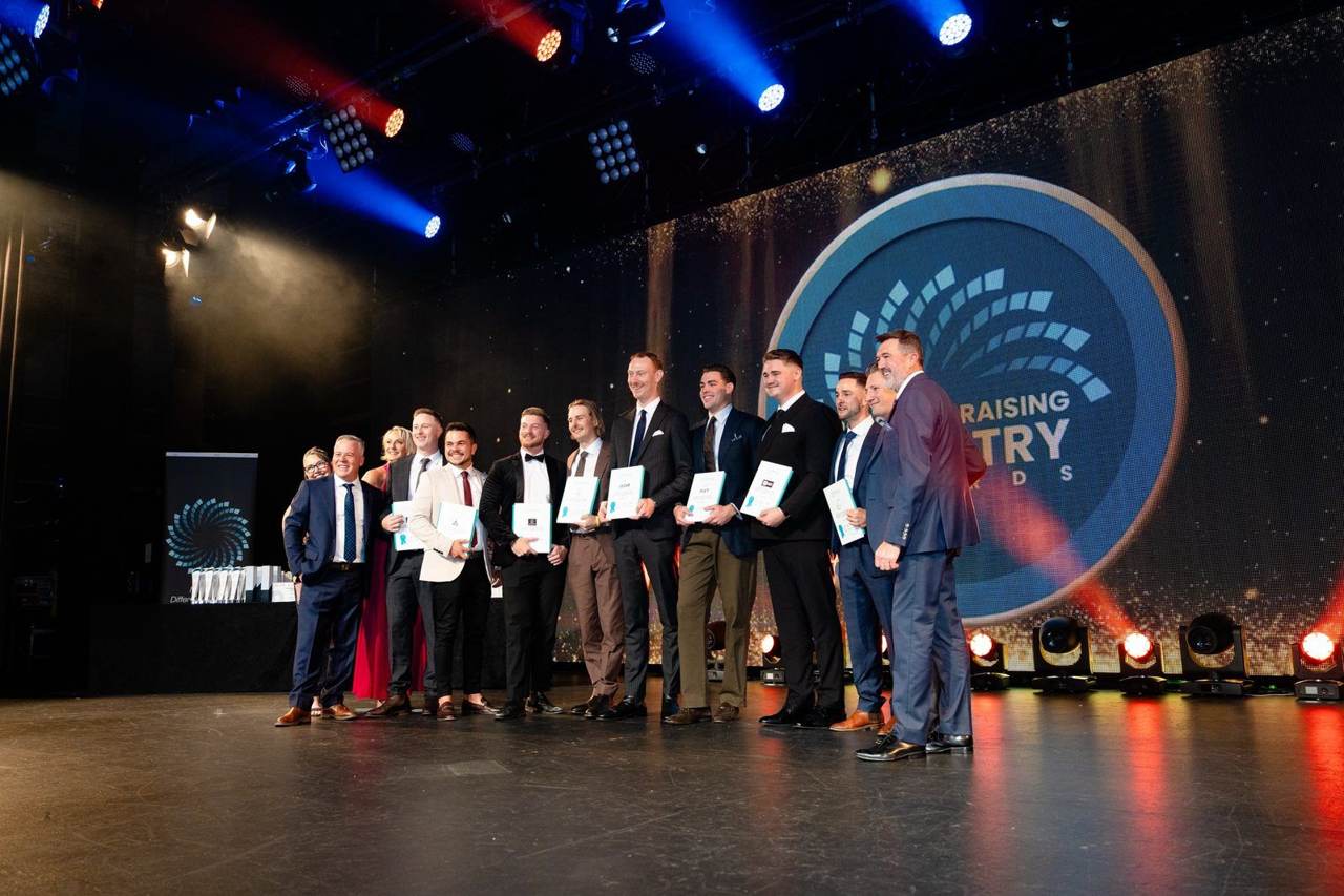 Minear Group leaders on stage at the FIN Gala