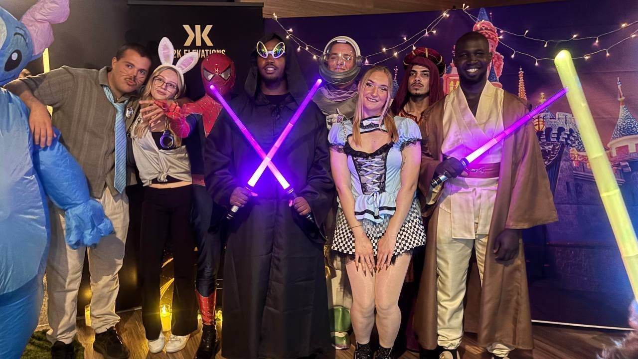 Team in costumes with glowing lightsabers