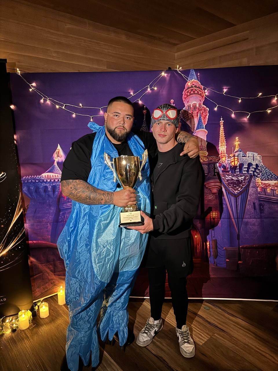 Two team members holding a trophy