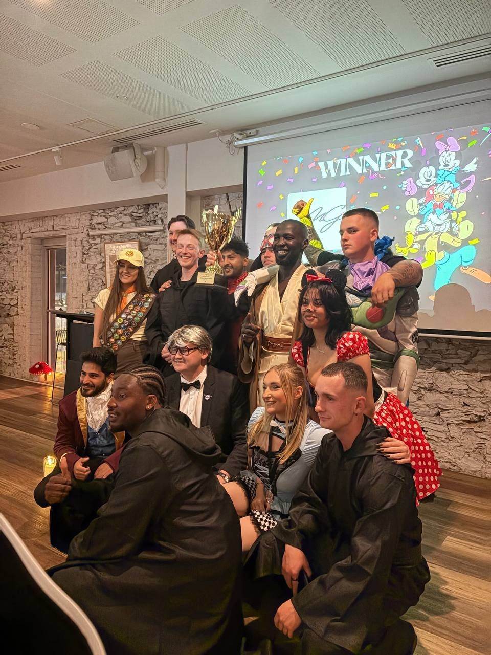 Team in costume celebrating with the trophy