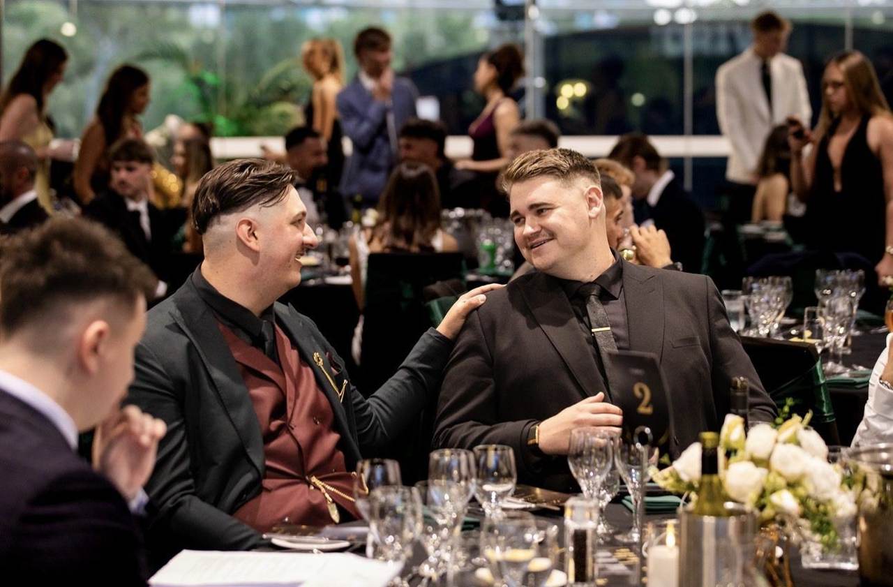 Two leaders sharing a laugh at a gala dinner