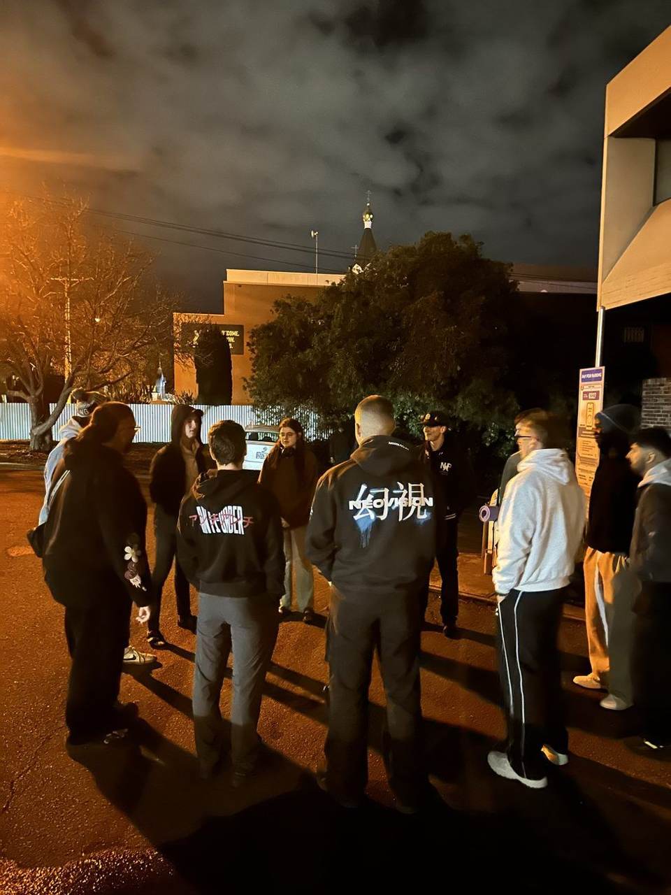 Team in a huddle outside at night