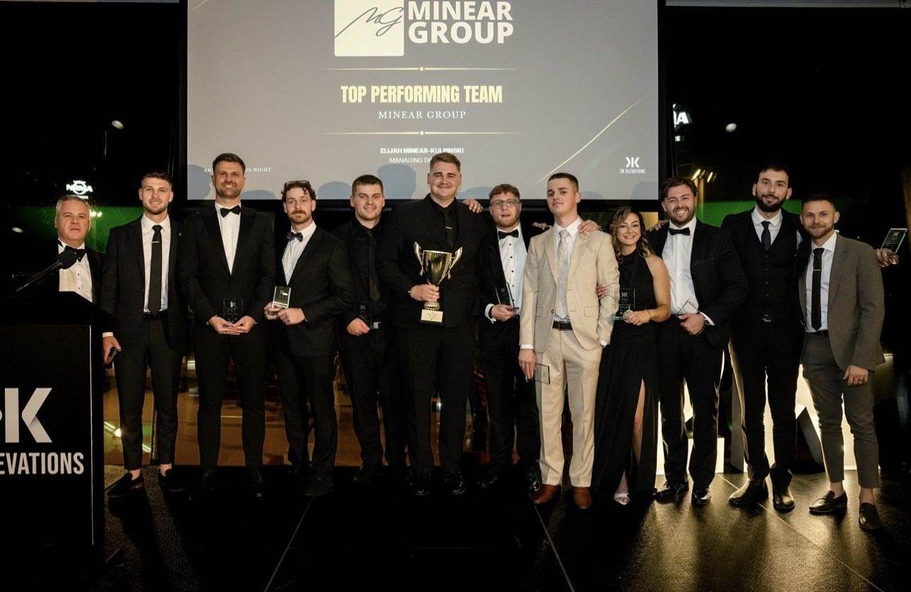 The team on stage accepting Top Performing Team